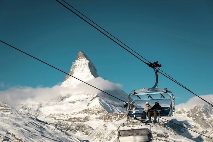 A chair lift/cable car with people on it in Zermatt, Switzerland