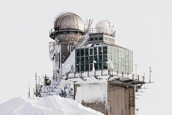 Panoramic view of the Sphinx Observatory at Jungfraujoch, Top of Europe, Switzerland, showcasing its impressive architecture set against a backdrop of snow-capped peaks and breathtaking alpine scenery.